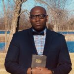 Brad D. Nelson Chritian Author and Speaker portrait holding bible